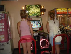 Lolly and Stef on a dance machine in the arcade